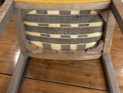 Wooden chair with a woven cushion on a wooden floor