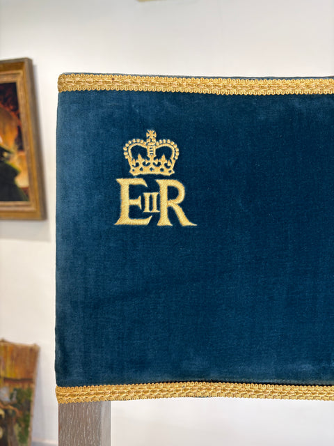 Blue velvet pillow with gold embroidery on a white background