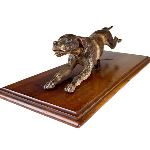 Bronze dog sculpture on a wooden base