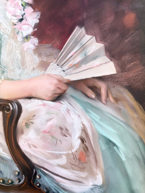 An impressionistic oil painting depicting a woman in a light aqua and white dress holding a folding fan, seated next to a dark wooden armchair with pink flowers in the background.