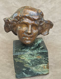 An Art Deco bronze head mounted on a marble pedestal signed N. Giordano