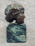 An Art Deco bronze head mounted on a marble pedestal signed N. Giordano