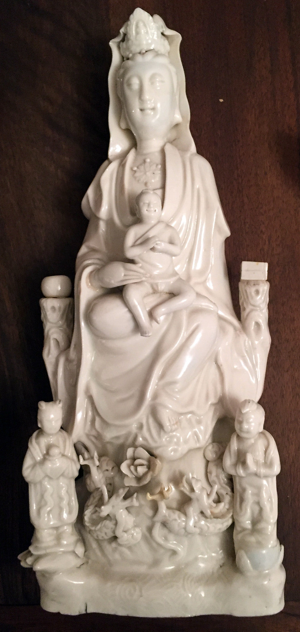 Seated Guanyin with Child — blanc de Chine porcelain, Kangxi period.
